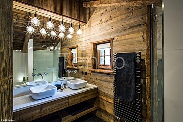 A bathroom with two sinks and a towel warmer