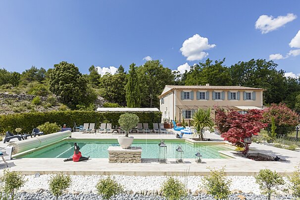 A large house with a swimming pool in front of it