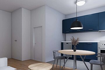 A modern kitchen and dining space featuring navy blue cabinets, a round wooden table with chairs, and minimalist decor in neutral tones.