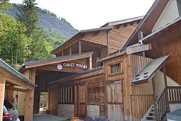 A wooden chalet with a sign that says chalet petites