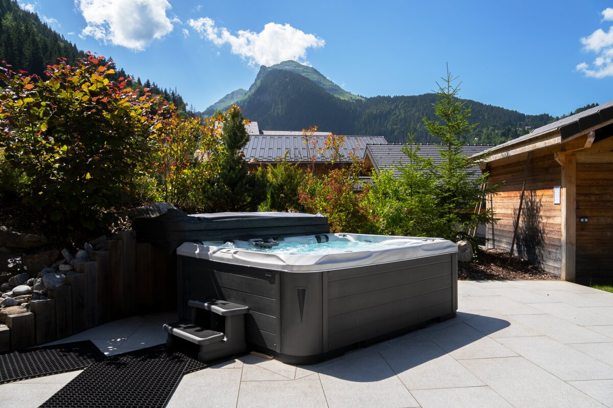 A hot tub with a mountain in the background