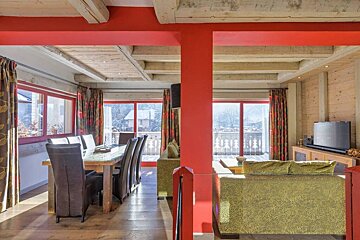 A living room with a dining table and chairs