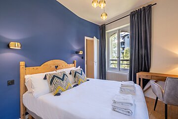 A bedroom with a large bed and a window