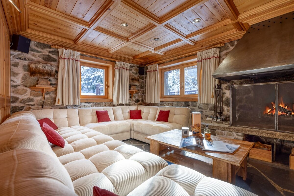 A living room with a large sectional couch and a fireplace