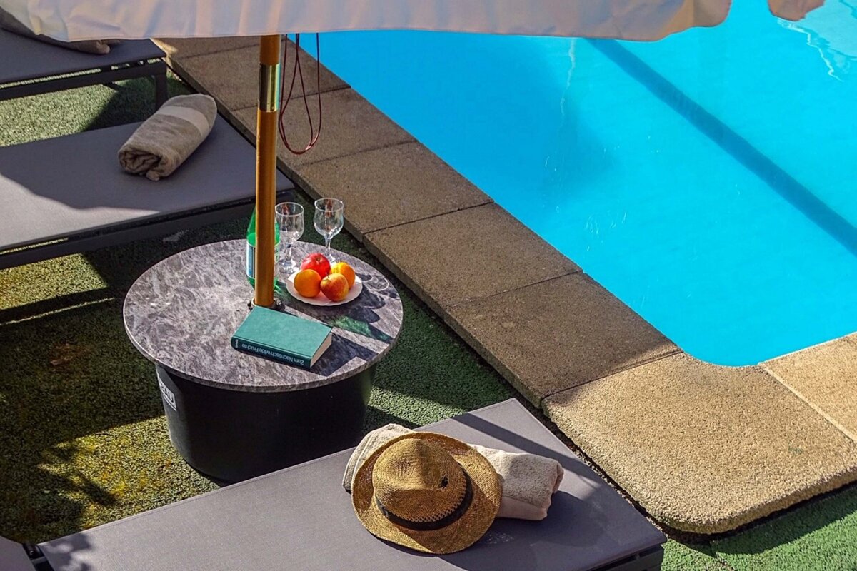 A book on a table next to a swimming pool