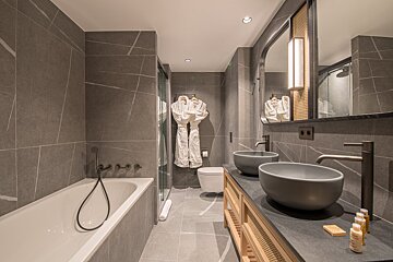 A bathroom with two sinks and a bathtub