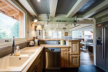 A kitchen with a sink and a stainless steel dishwasher
