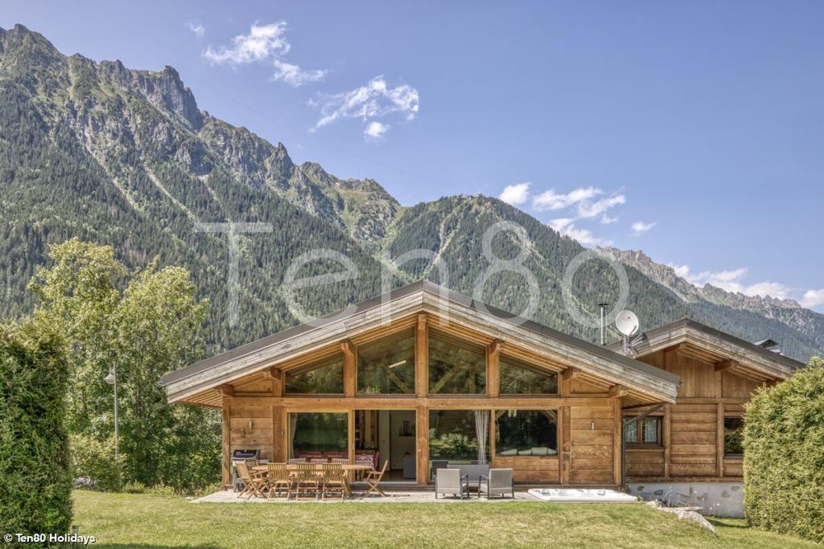 A picture of a chalet with mountains in the background taken by ten80 holidays
