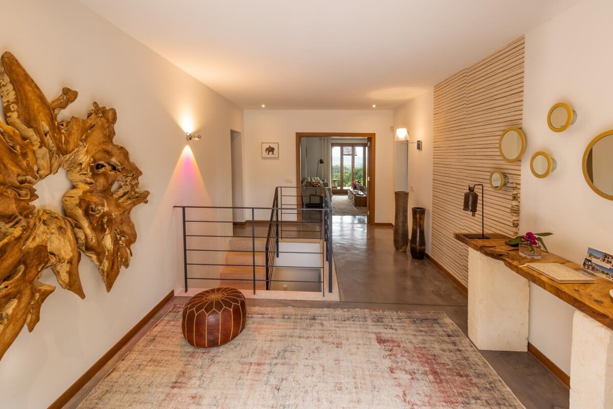 A hallway with a wooden sculpture on the wall