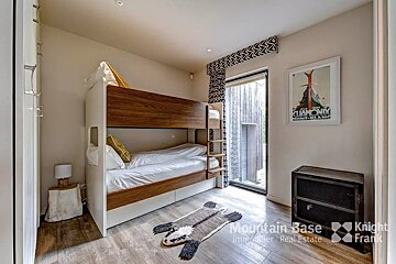 A bedroom with bunk beds and a poster that says chamonix