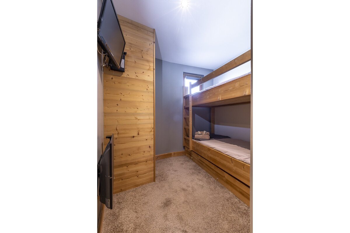 A bedroom with a painting of bison on the wall above the bed