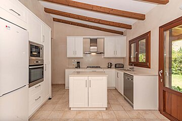 A kitchen with white cabinets and a lg refrigerator