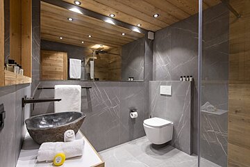 A bathroom with a toilet a sink and a mirror