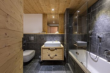 A bathroom with a toilet sink and bathtub