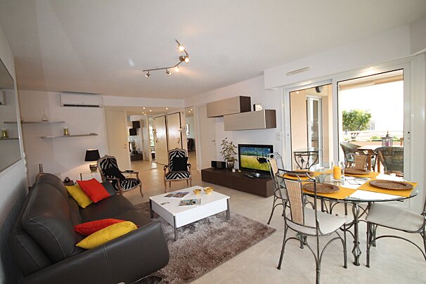 A living room with a couch and a table and chairs