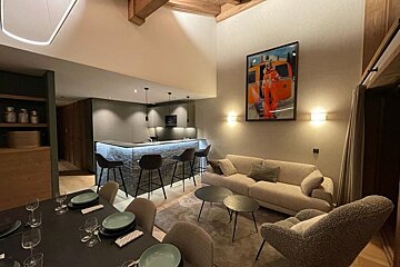 A living room with a couch a table and chairs