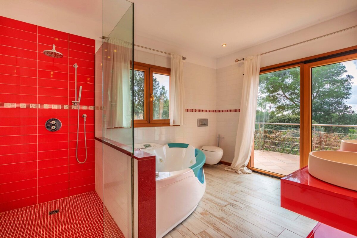 A bathroom with red tiles and a jacuzzi tub