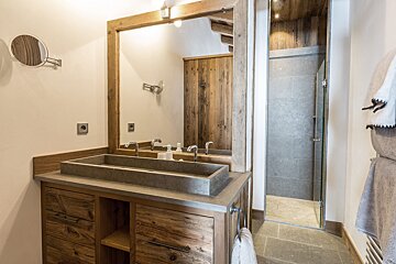 A bathroom with two sinks and a mirror