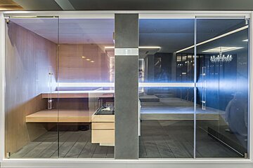 A room with a sliding glass door that looks like a sauna