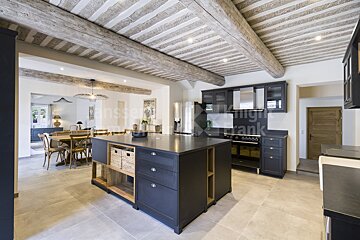 A kitchen with a large island in the middle and the word frank on the ceiling