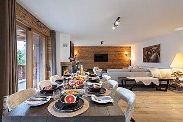 A dining room table with plates and bowls of food on it