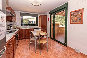 A kitchen with a table and chairs and a picture on the wall that says ' spice '