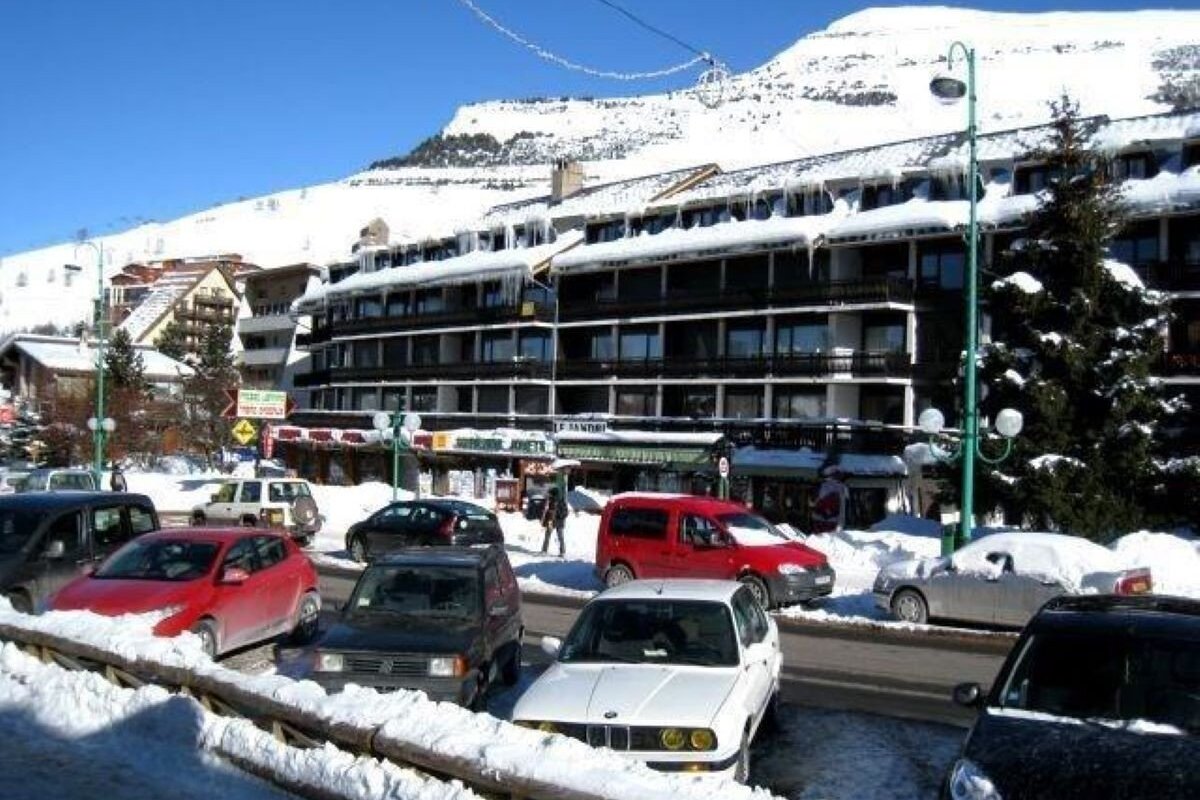 Cars are parked in front of a building with a sign that says ' ristorante ' on it