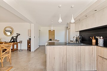 A kitchen with wooden cabinets and black counter tops