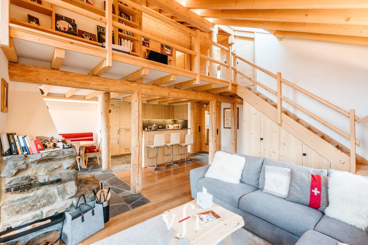 A living room with a couch that has a cross on it