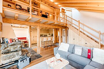 A living room with a couch that has a cross on it