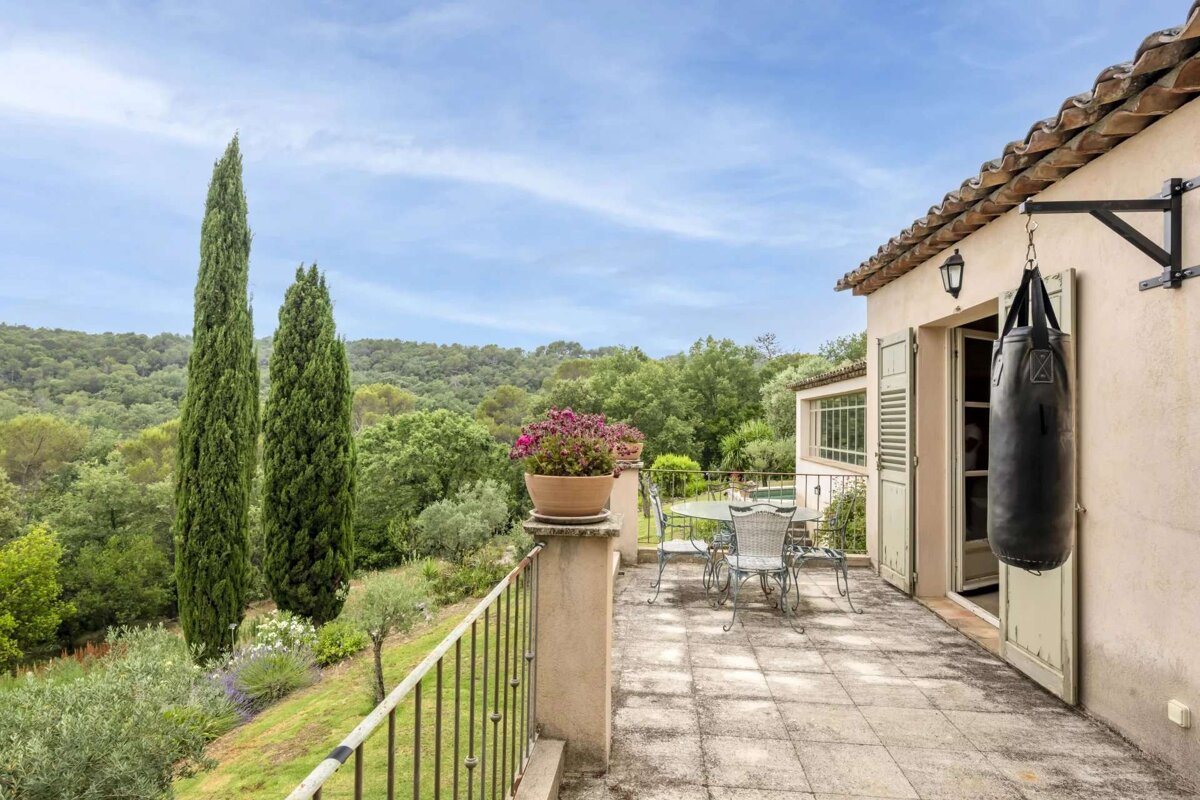 A boxing bag hangs from the roof of a house