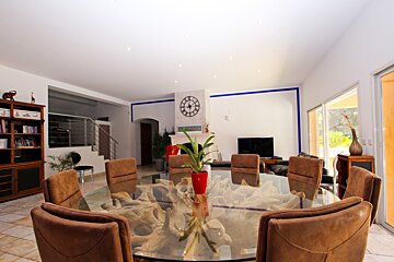A living room with a clock on the wall above the table