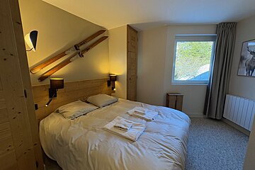 A bunk bed with a ladder leading up to it