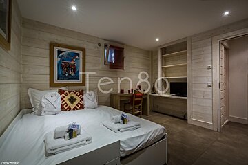 A bedroom with the number ten80 on the wall