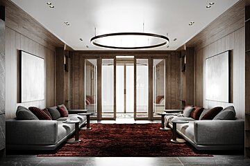 A living room with two grey couches and a red rug
