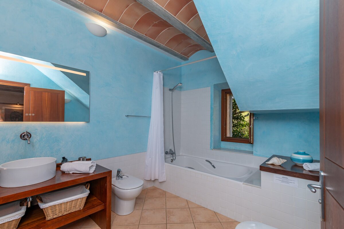 A bathroom with blue walls and a bathtub