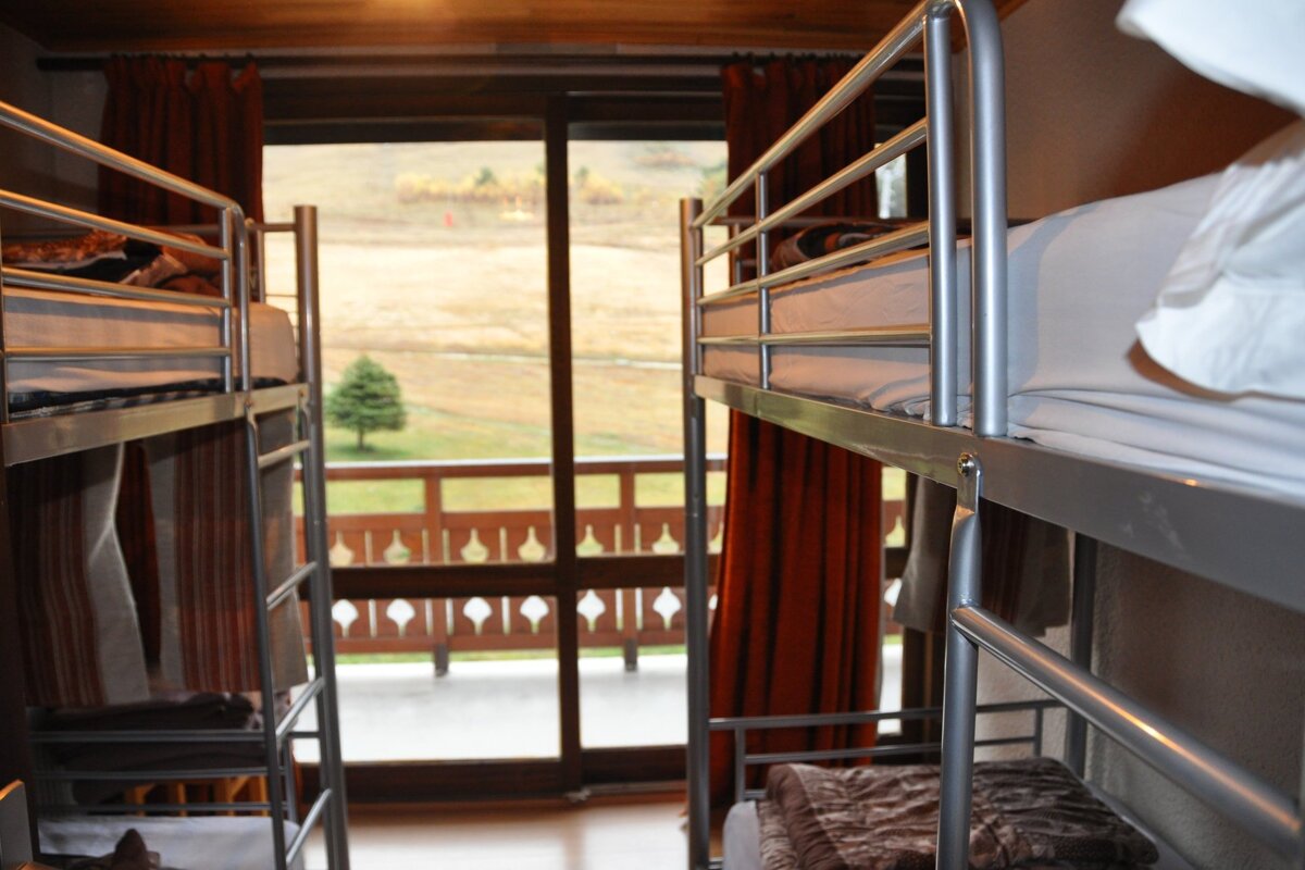 Bunk beds in a room with a view of a balcony