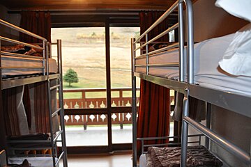 Bunk beds in a room with a view of a balcony