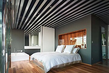 A bedroom with two beds and a bathtub