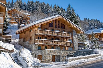 A snowy house with stairs leading up to it