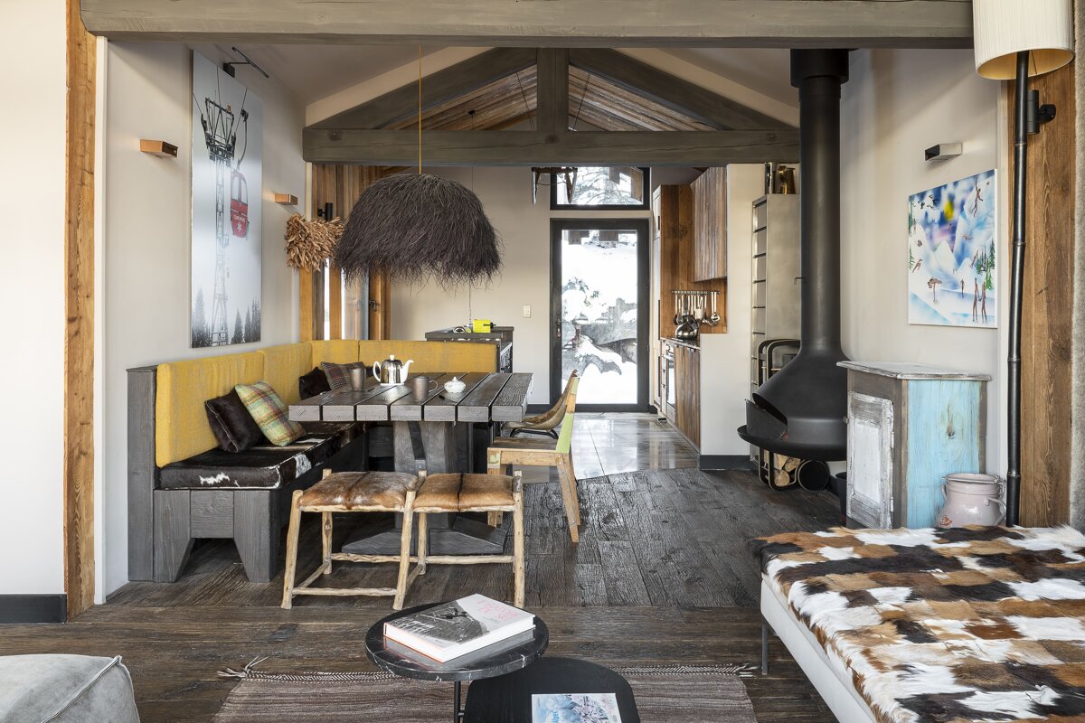 A living room with a table and chairs and a fireplace