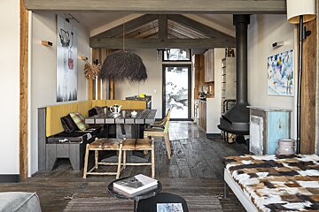 A living room with a table and chairs and a fireplace