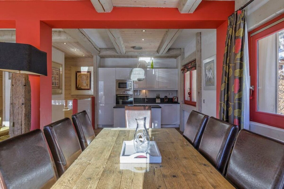 A wooden table with a vase on it in a kitchen