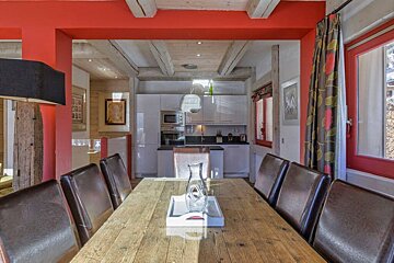 A wooden table with a vase on it in a kitchen