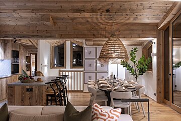 A living room with a dining room table and chairs