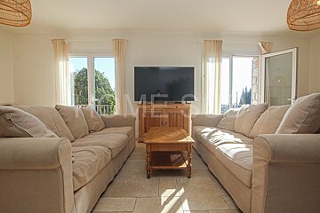 A living room with two couches and a flat screen tv