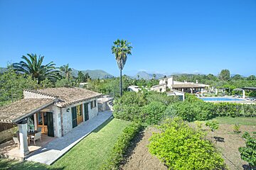 An aerial view of a house with a pool in the background