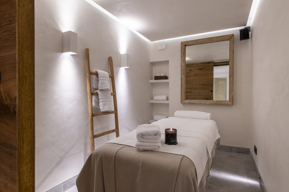 A massage table with towels and a candle on it