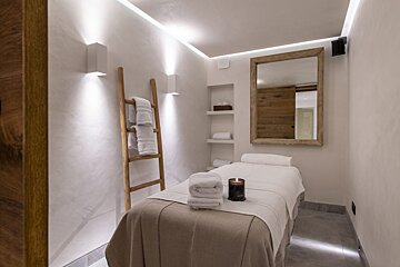 A massage table with towels and a candle on it