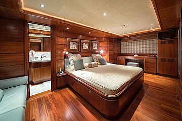 A bedroom with a large bed and a blue couch